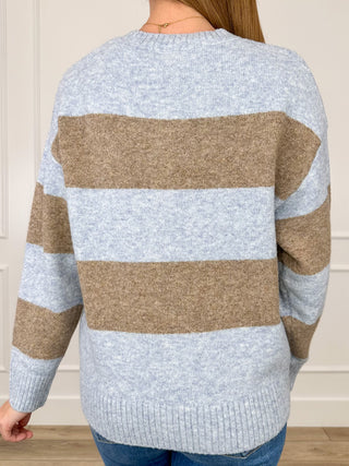 Back view of blue-and-tan striped knit sweater with ribbed hem and long sleeves