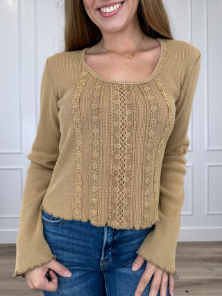Tan long-sleeve cropped knit top with lace-trim panel and round neckline