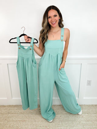 Mint green sleeveless jumpsuit on hanger, gathered waist and wide legs.
