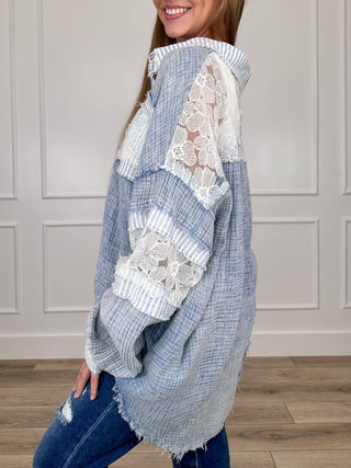 Blue cotton tunic top with lace sleeve panels, ruffle cuffs, side frayed hem