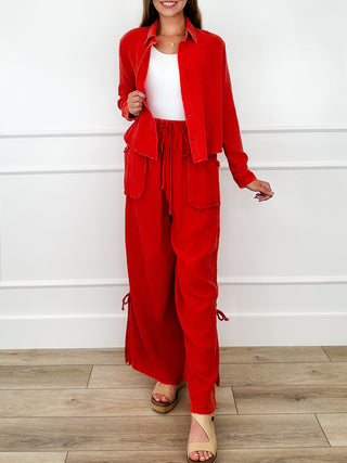 Red two-piece cotton wide-leg set with cropped buttonless jacket and high-rise pants