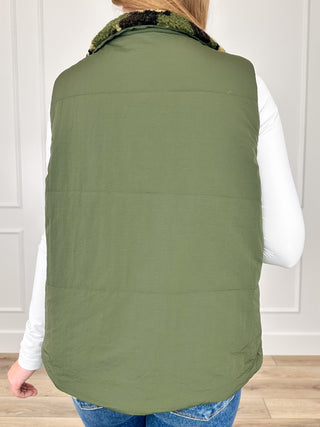 Reversible green vest back view with stand collar and zipper