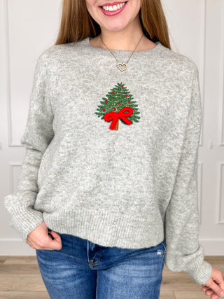 Grey knit long sleeve sweater with Christmas tree and red bow graphic