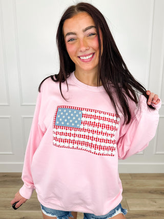 Pink lightweight crewneck sweatshirt with long sleeves and star-spangled striped chest graphic