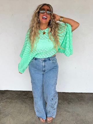 Mint green cropped knit sweater top with long sleeves and open diamond-textured knit