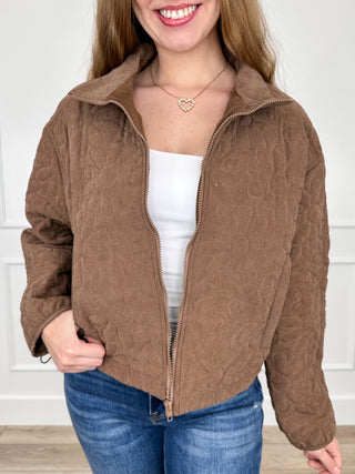 Brown quilted cropped long-sleeve jacket with front zipper and stand collar.