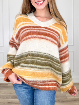 Cream striped knit long-sleeve sweater with orange and olive horizontal bands