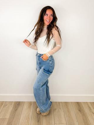 White long-sleeve top and light blue distressed jeans outfit
