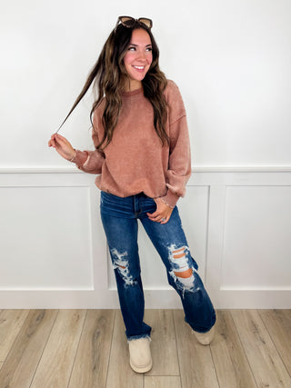 Sweatshirt and distressed jeans outfit with beige ankle boots