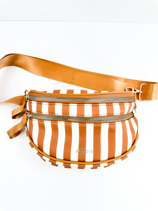 Orange and white striped neoprene crossbody bag with adjustable tan shoulder strap and zipper