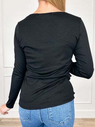 Black rayon-blend long sleeve top, back view, ruched waist and fitted sleeves