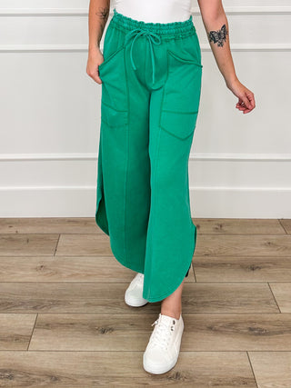 High-rise green cotton-blend pants with drawstring waist and patch cargo pockets