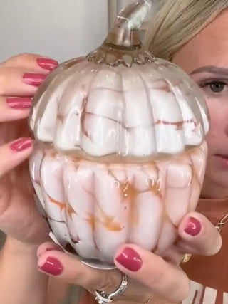 Cream pumpkin-shaped candle holder with ribbed glass and gold-toned top