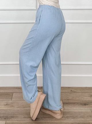Light blue high-rise striped trousers with relaxed straight legs and front buttons
