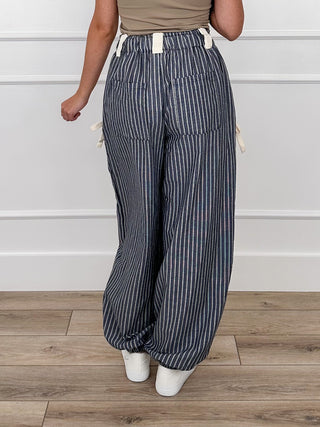 High-rise knit striped pants with elastic waist, navy pinstripe and cuffed jogger hems