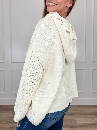 Ivory hooded knit long-sleeve sweater, textured pattern and relaxed side drape