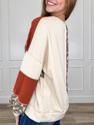 Colorblock knit long-sleeve top, cream back with rust knit and gray floral side panels