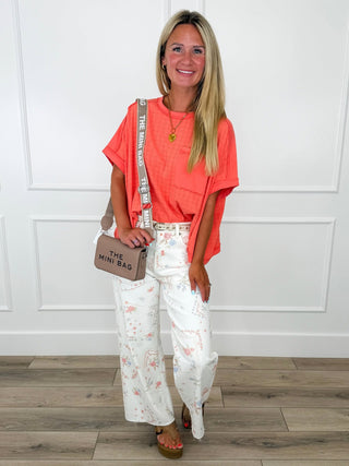Coral T-shirt and white floral wide-leg pants outfit