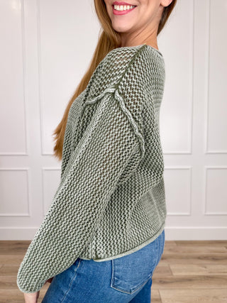 Green cotton knit sweater, long sleeves and crew neck, side view