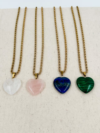 Gold heart pendant necklace set with white, pink, blue, and green heart charms