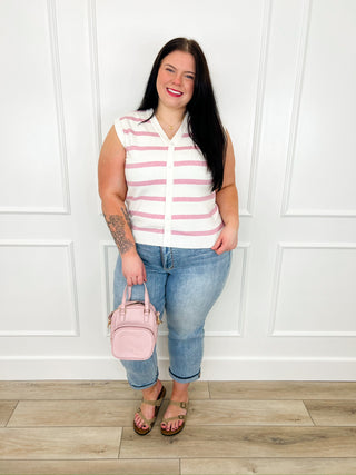 Outfit with sleeveless striped top, blue jeans, tan sandals, and pink crossbody bag