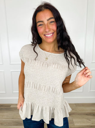 Heathered taupe short-sleeve peplum top with ruched tiers and smocked knit