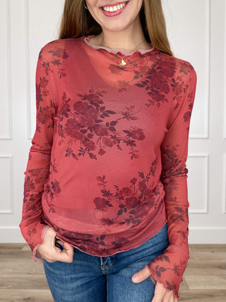 Red sheer mesh long-sleeve top with dark floral print and henley-style neckline
