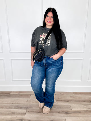 Dark wash straight-leg jeans, distressed detailing at the thighs and knees