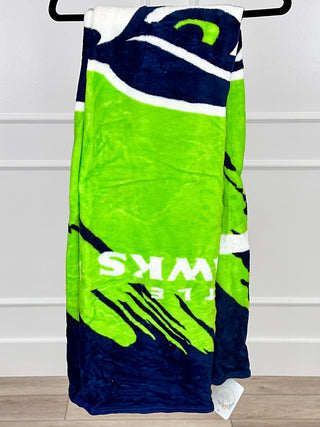Cold Defense throw blanket with navy and bright green graphic pattern, white stripes