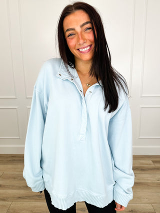 Light blue cotton pullover sweatshirt with partial button placket and ribbed cuffs