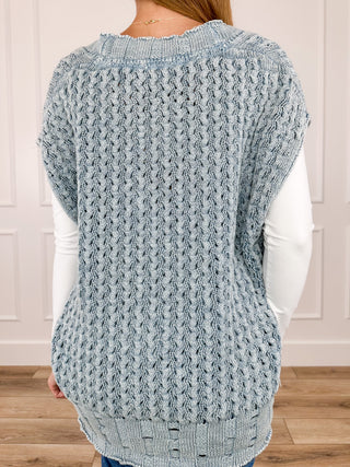 Light blue cotton knit sweater vest back with textured cable pattern and ribbed hem