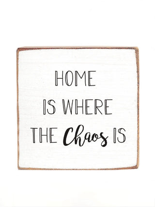 Wood block sign with "HOME IS WHERE THE Chaos" quote.