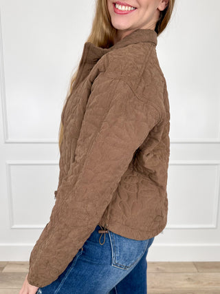Brown quilted long-sleeve jacket, side view, with front zipper and stand collar.