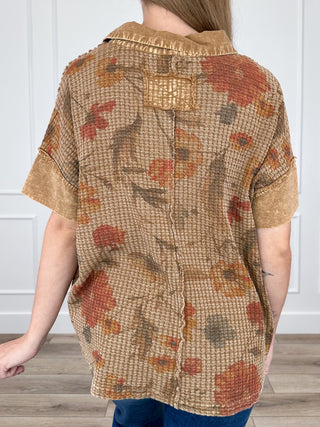 Brown floral short-sleeve knit top with collared back and button placket