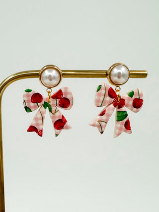 Gold-tone drop earrings with pearl beads and cherry bow charms