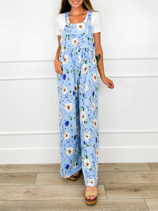 Light blue floral printed overalls with adjustable straps and wide straight legs