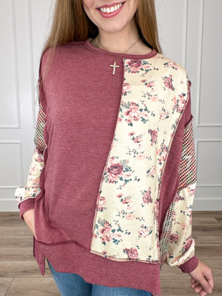 Berry knit long-sleeve top with floral cream side panel and rounded hem