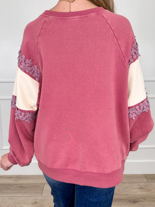 Pink and cream crewneck sweatshirt with floral lace trim on raglan sleeves