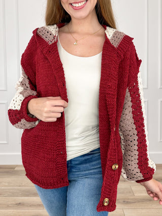 Burgundy hooded knit cardigan with long sleeves, patchwork sleeves, button front