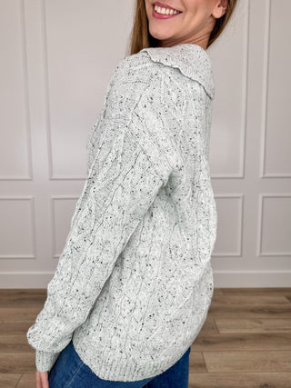 Light grey speckled knit cardigan with button front and long sleeves, ribbed cuffs