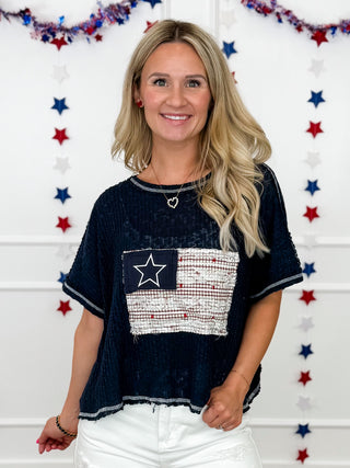 Navy knit cropped top with star-and-flag front patch and crew neckline
