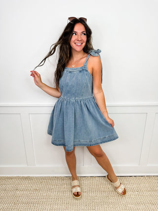 Blue sleeveless denim mini dress with square neckline and gathered waist