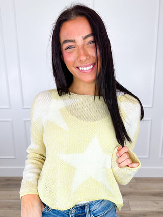 Cream yellow cropped knit sweater with long sleeves and pale yellow star pattern, scoop neck