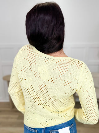 Light yellow long-sleeve knit sweater top, open-knit geometric eyelet pattern