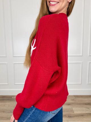 Red long-sleeve knit sweater, crew neck, side view