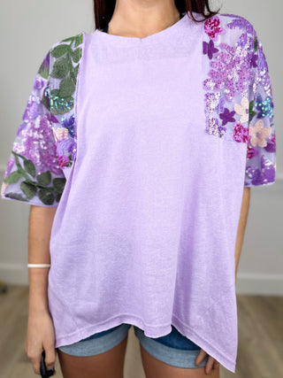 Lavender short-sleeve top with purple floral puff sleeves and round neckline