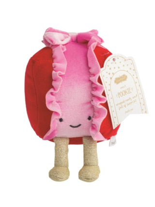 Holiday snuggles plush gift with pink ruffled top, red side, tag, small smile face, tan glitter feet