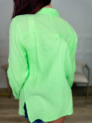 Cotton long-sleeve button-up top in lime green, back view with full-length sleeves.