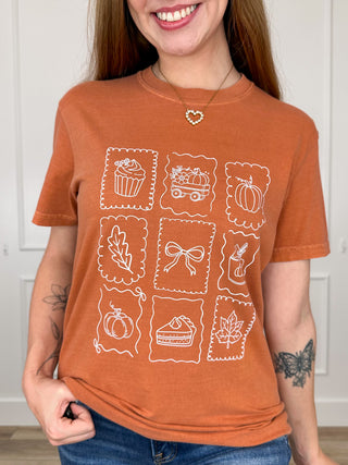 Orange short-sleeve cotton graphic tee with fall food icon grid print
