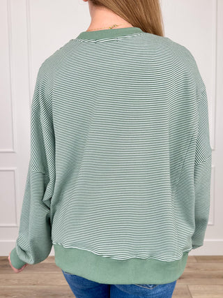 Back view of green striped long-sleeve sweatshirt with crew neck and ribbed hem